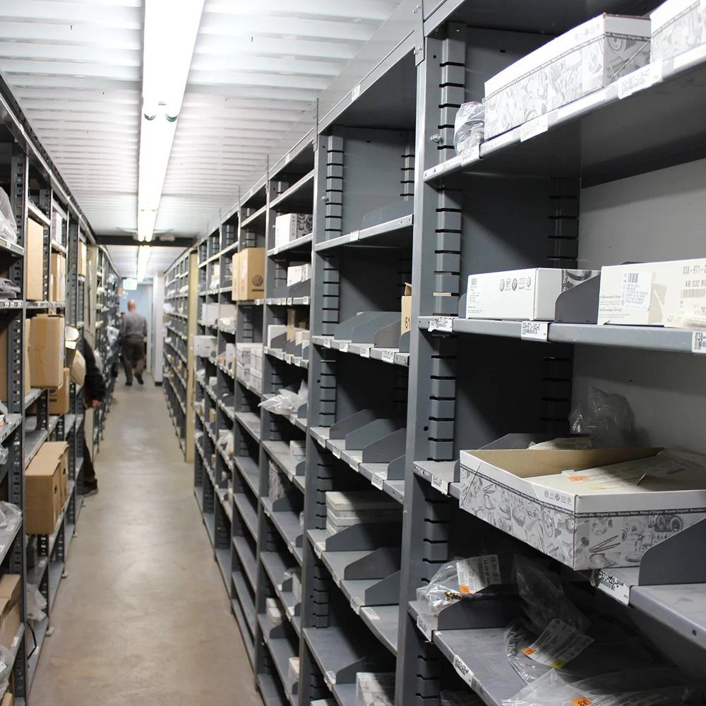 Long aisle of Borroughs parts shelving in an automotive stockroom