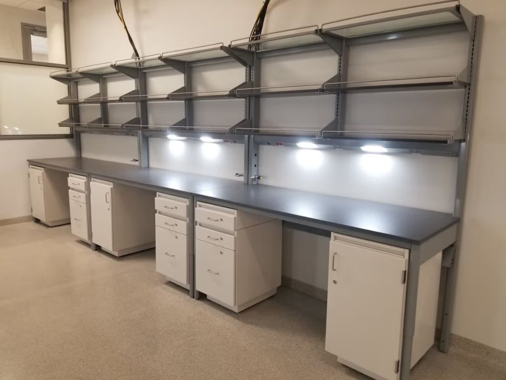 ICI Envision workbenches with elevated shelves and white mobile storage cabinets