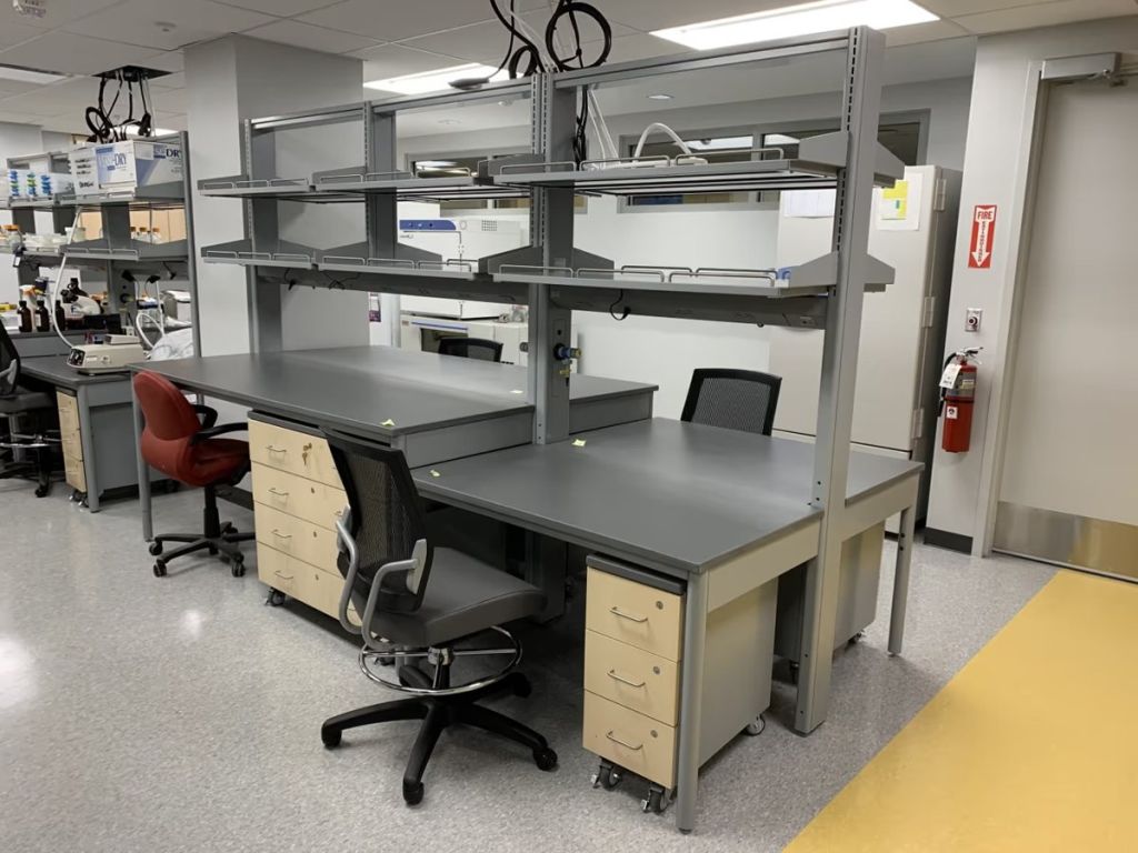 ICI adjustable laboratory workstation with overhead shelving and seated knee space