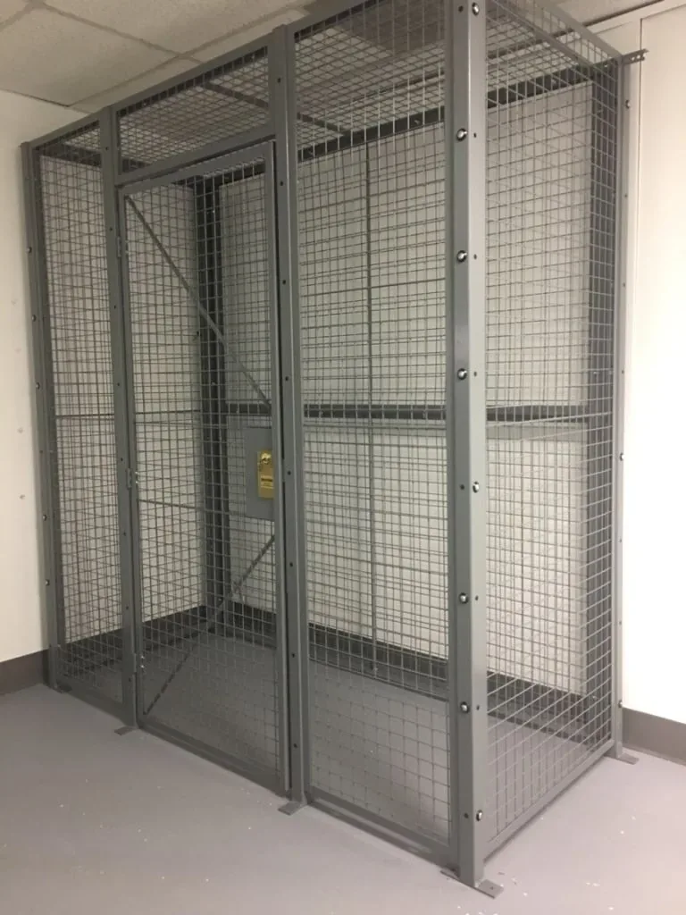 Real installed security cage with a hinged wire mesh door open for access