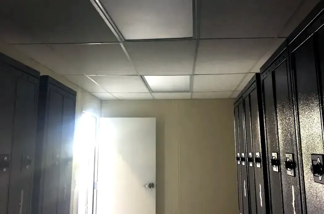 Rows of full-height black steel employee lockers inside a modular change room installed in a Salt Lake City industrial facility