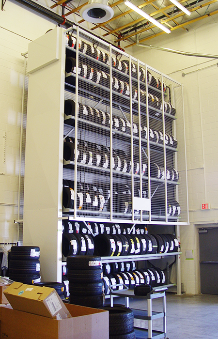 Technician retrieving a tire from a Vidir Tire Carousel