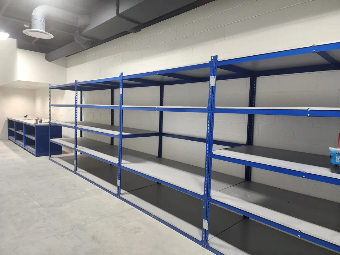 Blue Borroughs Rivet-Span bulk shelving with decked levels along a wall of the Young Subaru parts room