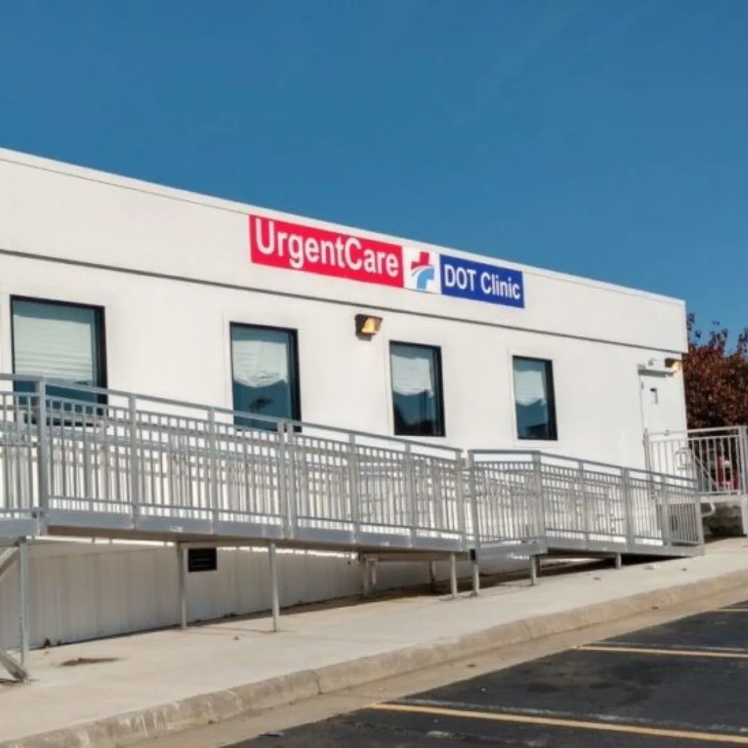 White modular clinic building with an accessible ramp and handrails