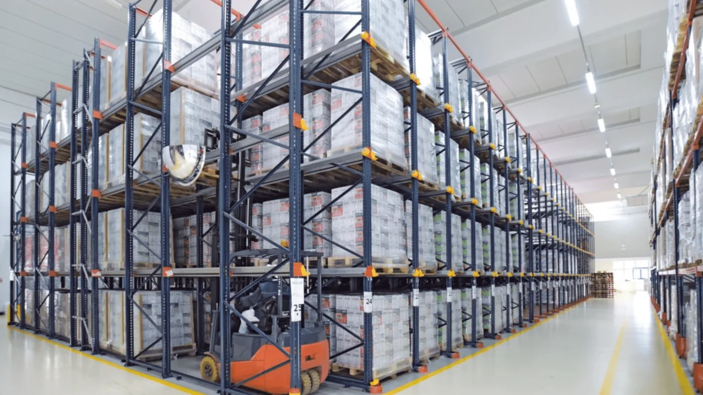 High-density Interlake pallet rack aisle with a forklift and stacked pallet loads