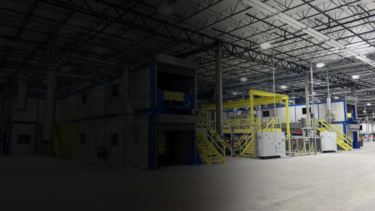 Multi-story modular structures with steel stairs and platforms installed on a manufacturing floor
