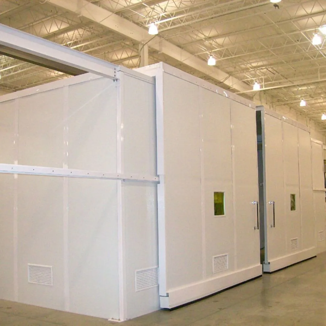 Long white modular room built inside a high-bay facility