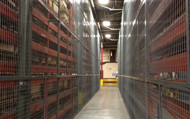BeastWire wire mesh pallet rack backing panels lining both sides of a warehouse aisle