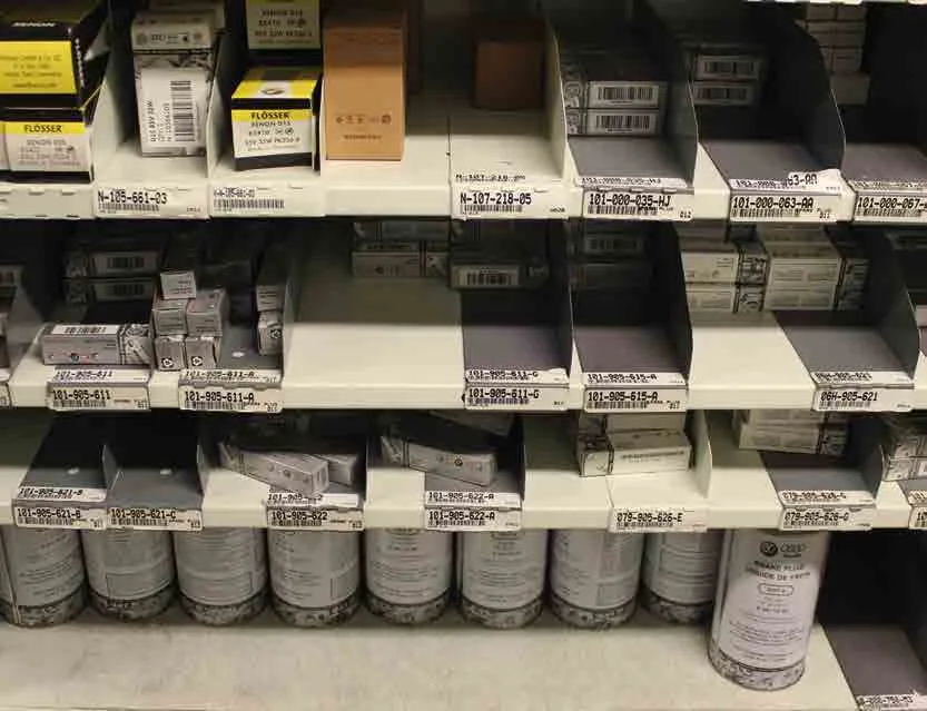 Borroughs Flexi-Bin shelves with dividers holding boxed filters, parts and fluid cans