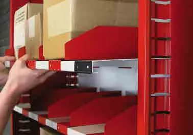 Hand adjusting a slide-in shelf on red Borroughs Flexi-Bin shelving with sliding dividers