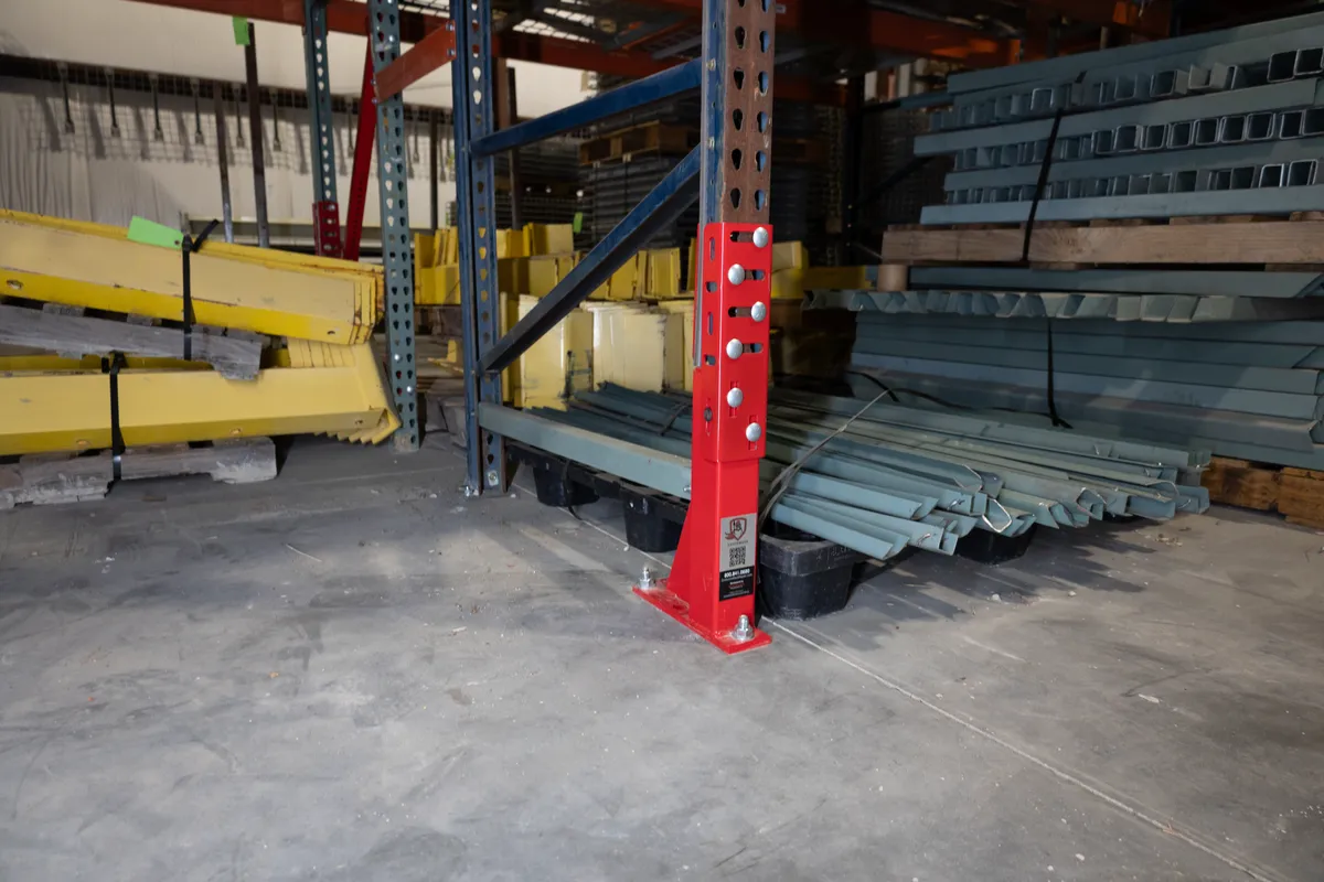 Centurion Low Guard repair kit bolted to the base of a damaged pallet rack upright
