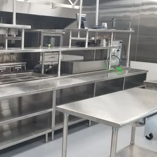 Eagle Group stainless steel work table and shelving in a commercial kitchen