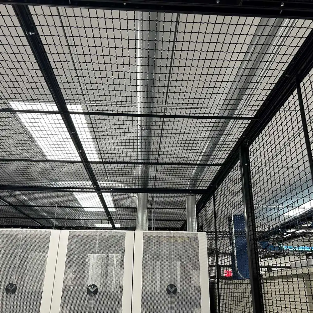 Floor-to-ceiling wire mesh cage with mesh ceiling panels over server cabinets