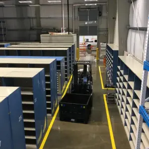 Rows of closed Hallowell steel bin shelving with blue end panels in a parts room (photo: Hallowell)