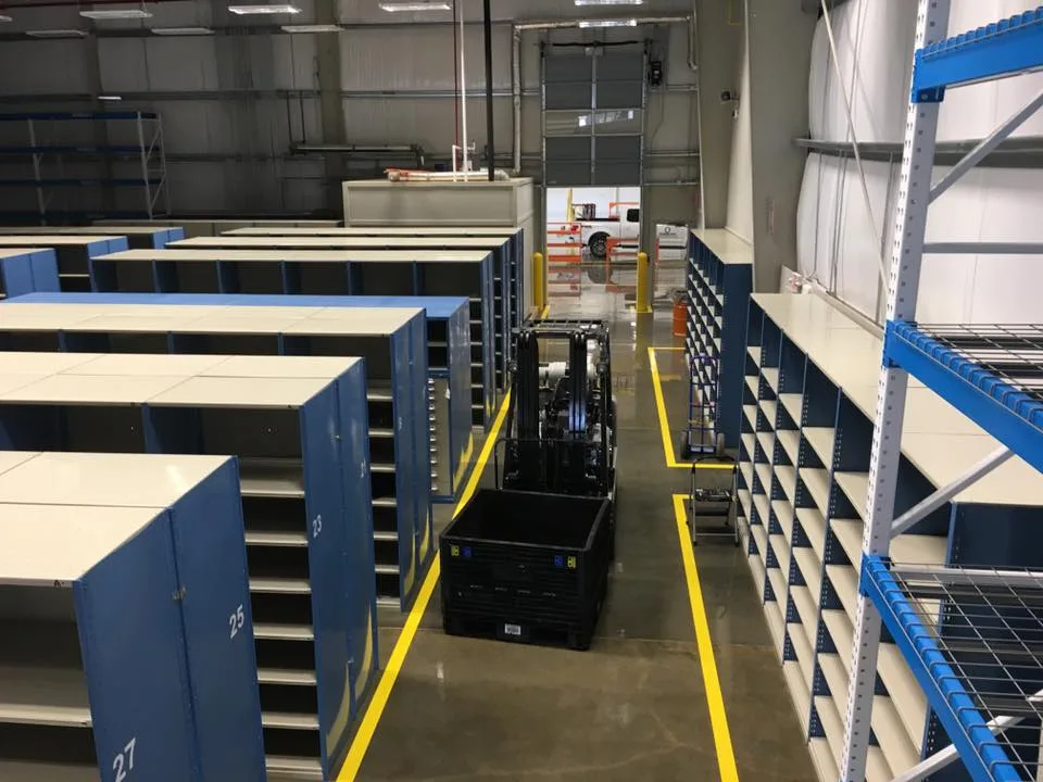 Rows of closed Hallowell steel bin shelving with blue end panels in a parts room (photo: Hallowell)
