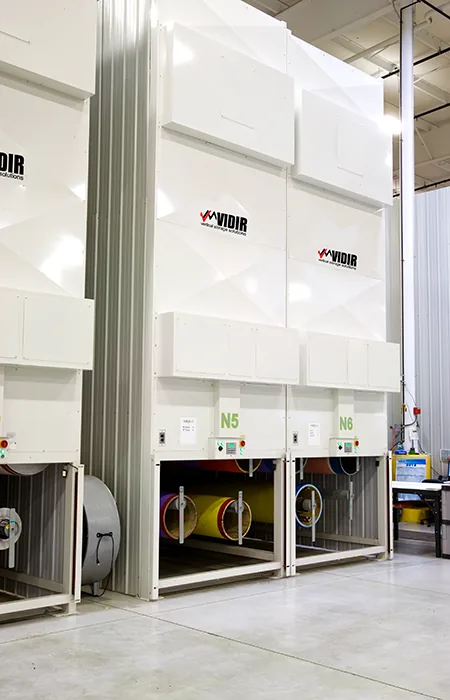 Loading openings of enclosed Vidir Hollow Core Carousels showing stored printing sleeves at waist height