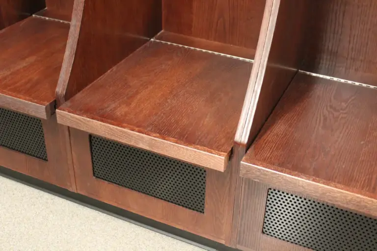 Close-up of Olympian wood locker seat boxes with perforated ventilation panels