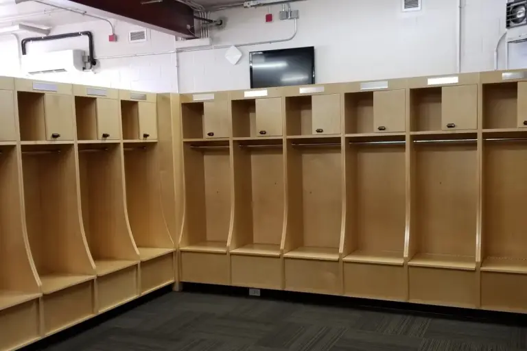 Maple ICI Olympian open team lockers with seat boxes lining a varsity locker room