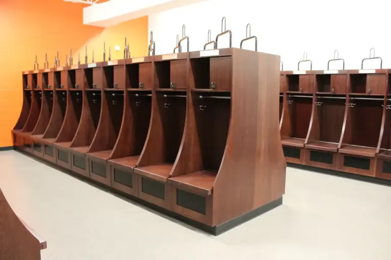 ICI Olympian wood athletic lockers with curved side panels in a team locker room