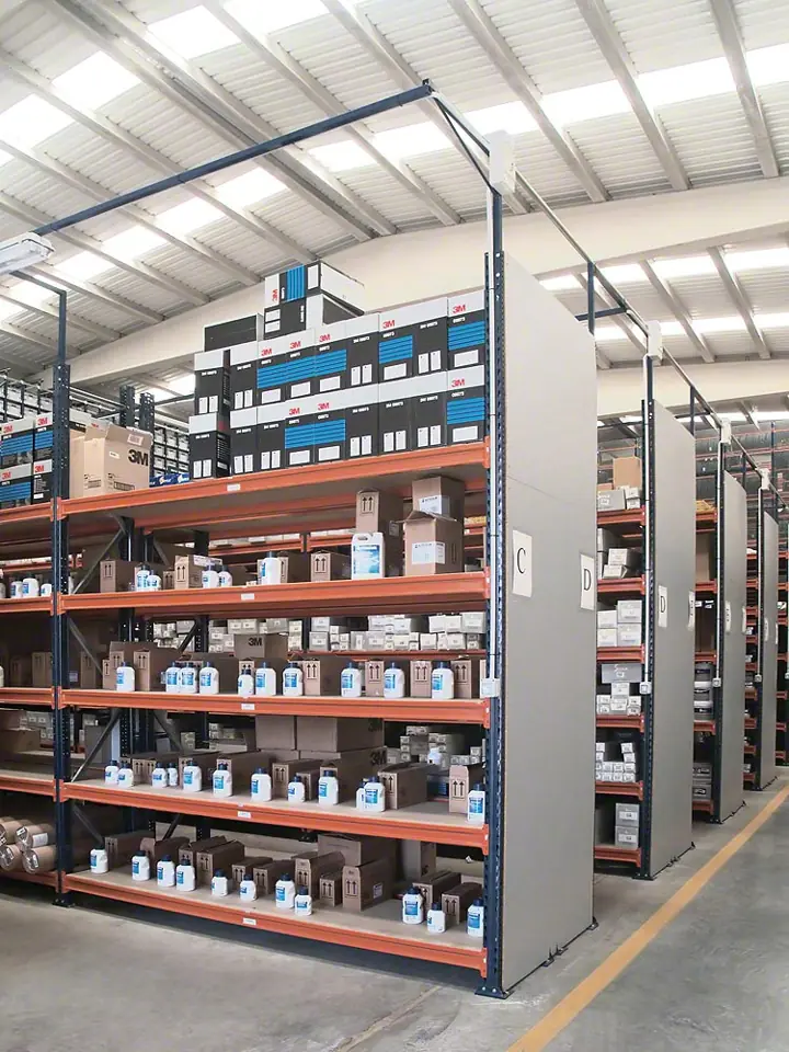 Longspan shelving in a parts storeroom with orange beams, steel decks and closed gray end panels