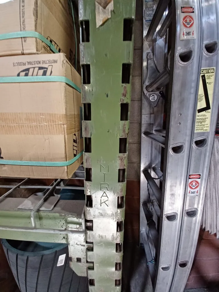 Older MIRAK-branded pallet rack upright at Motion Industries before replacement