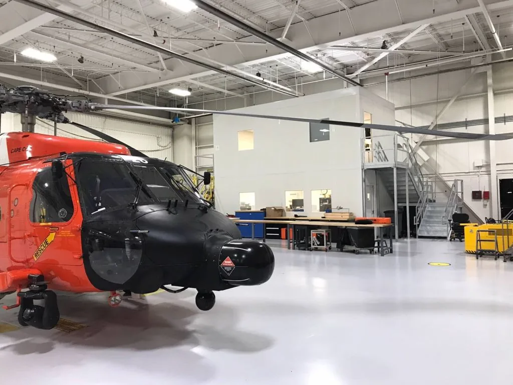 Modular offices with an upper level inside an aircraft hangar