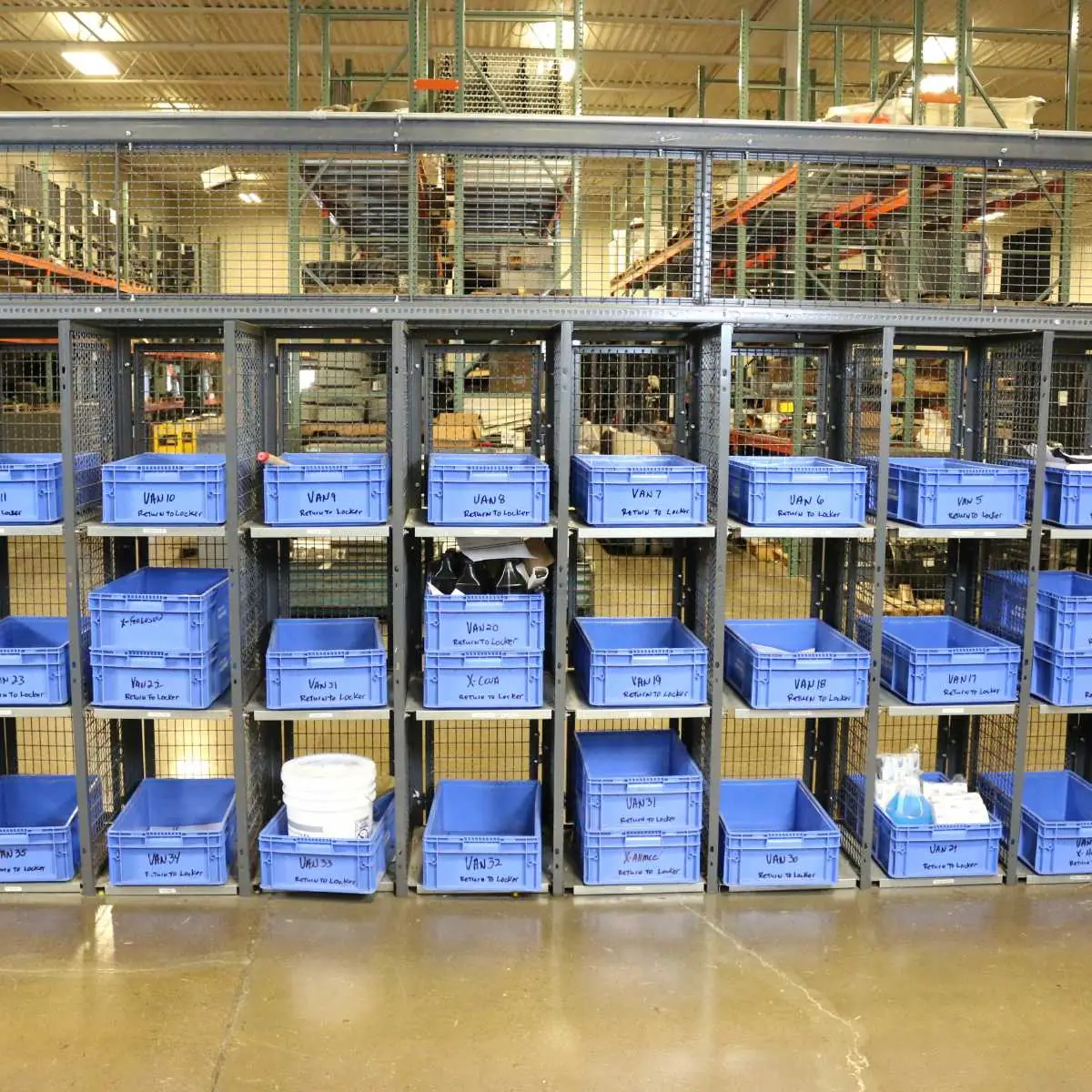 Parts department wire mesh technician lockers loaded from inside the cage