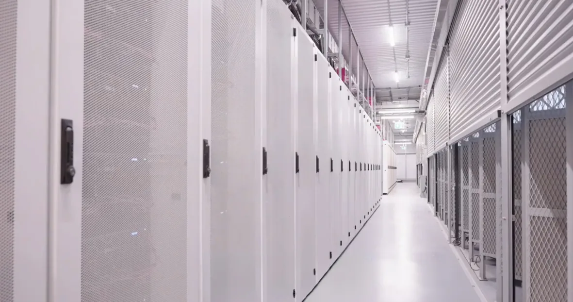 Long secure storage corridor with locking roll-up shutters on storage units and mesh partitions