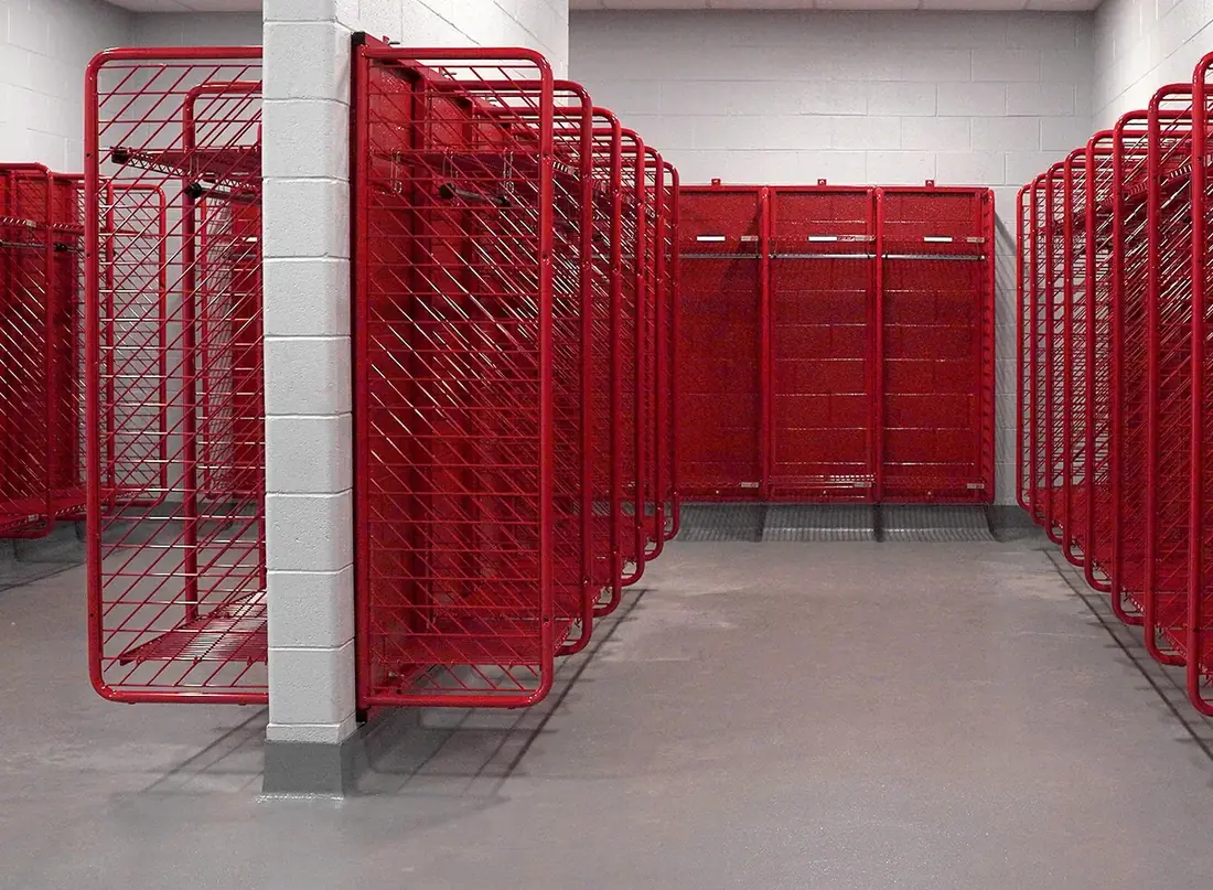 Rows of red Ready Rack Red Rack turnout gear lockers installed in a fire station gear room