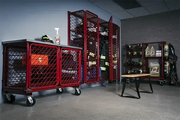 Red worktable system with lower storage beside tool storage lockers and a gear bench