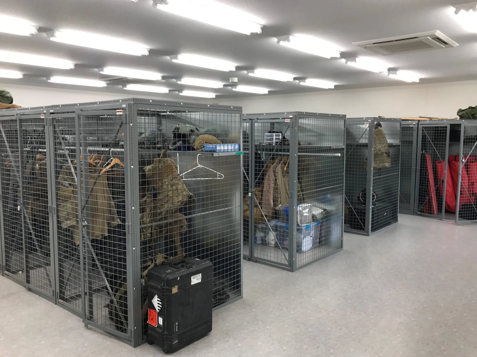 Gray SpaceGuard BeastWire wire mesh lockers holding military gear inside a large facility