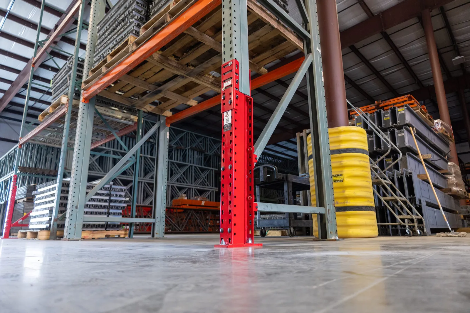 Red SpaceGuard Centurion VanGuard repair kit reinforcing a pallet rack upright