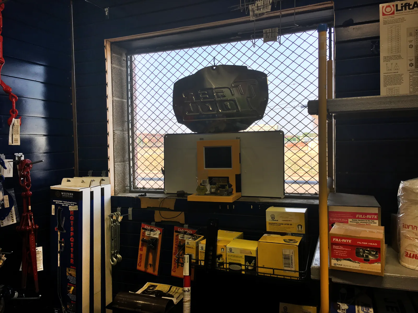 FordLogan diamond-mesh window infill panel over a parts-counter window