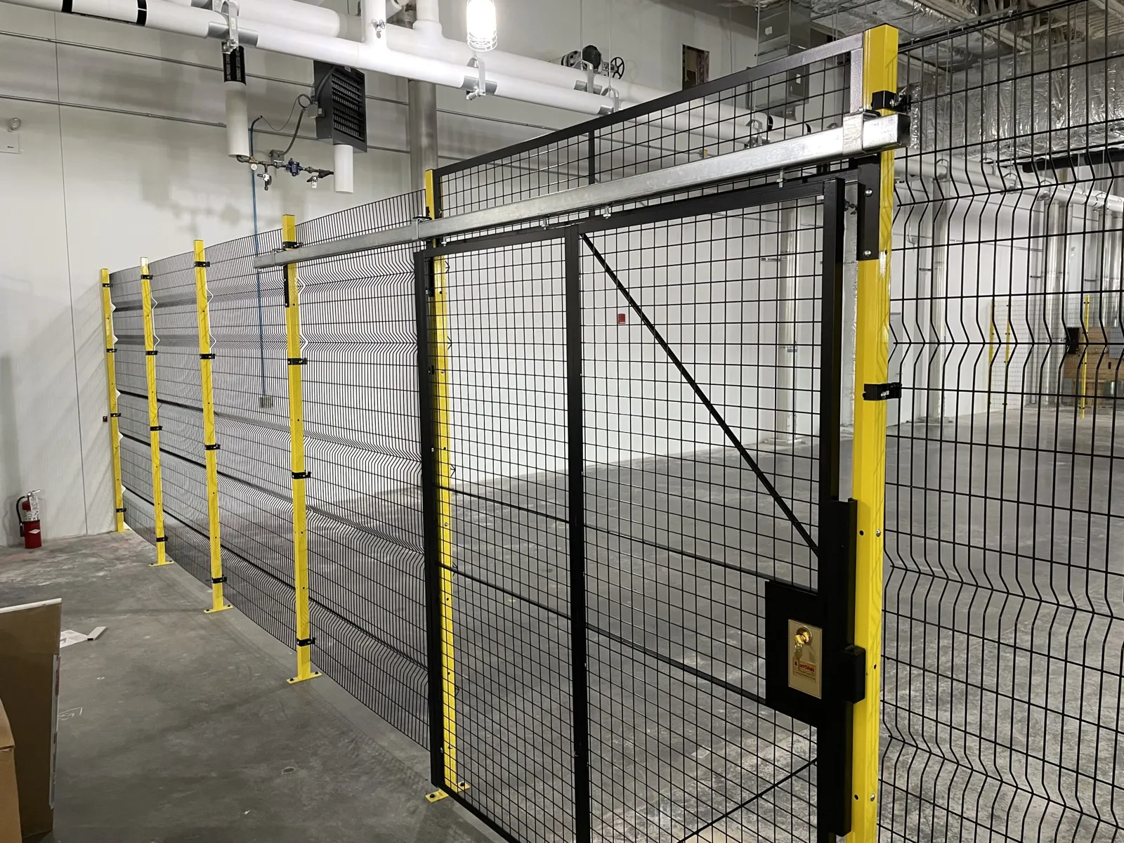RageWire frameless mesh partition with yellow posts and a black BeastWire sliding door