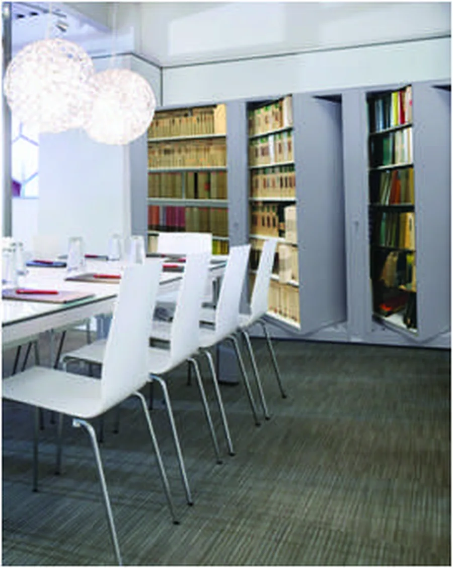 Times-2 rotary cabinets set into a meeting-room alcove beside the table, opened to binders