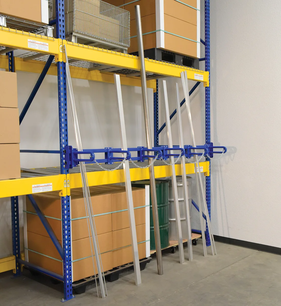 Vestil vertical bar storage rack bolted across pallet rack uprights holding long aluminum stock upright against the rack