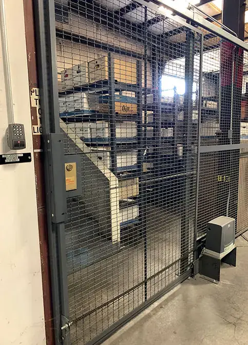 Hinged wire mesh door with lock on an evidence and records storage enclosure