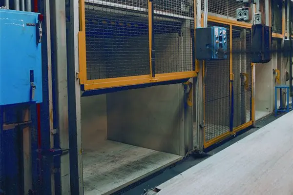 Wire Crafters vertical rise mesh doors on vertical lift storage openings in an industrial facility