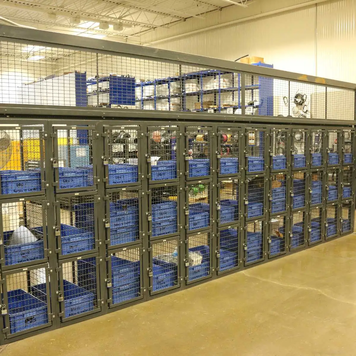 Wire mesh technician locker system with blue parts bins in each compartment at a distribution center